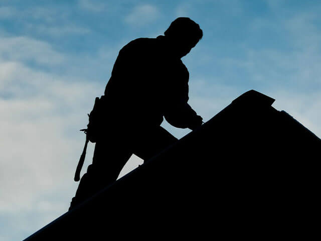 Horizontal image of worker from roof repair company in Kansas City