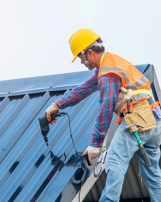 Worker repairing roofing in Kansas City