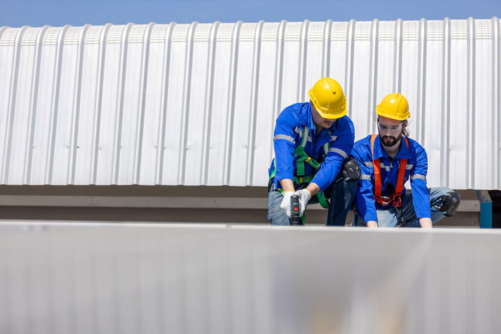workers installing TPO roofing Kansas City