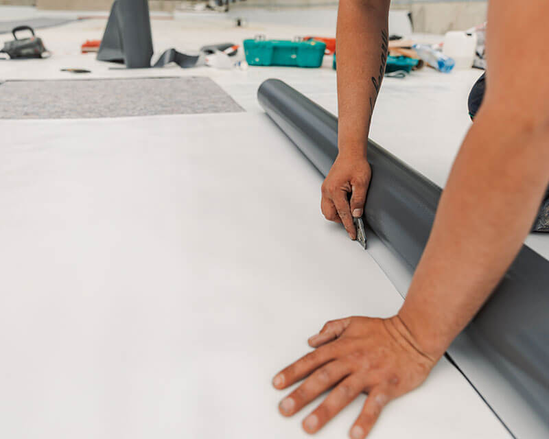 expert cautting TPO roofing material in Kansas City
